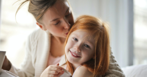 mother wonders if gum disease is hereditary as she kisses daughter's head