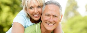 An old couple with confident smiles and dental implants